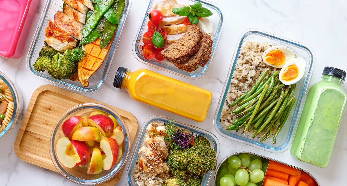Colorful healthy Malaysian meal prep containers with rice, lean protein, vegetables, fruits, and snacks, showcasing balanced, easy-to-make meals for busy individuals